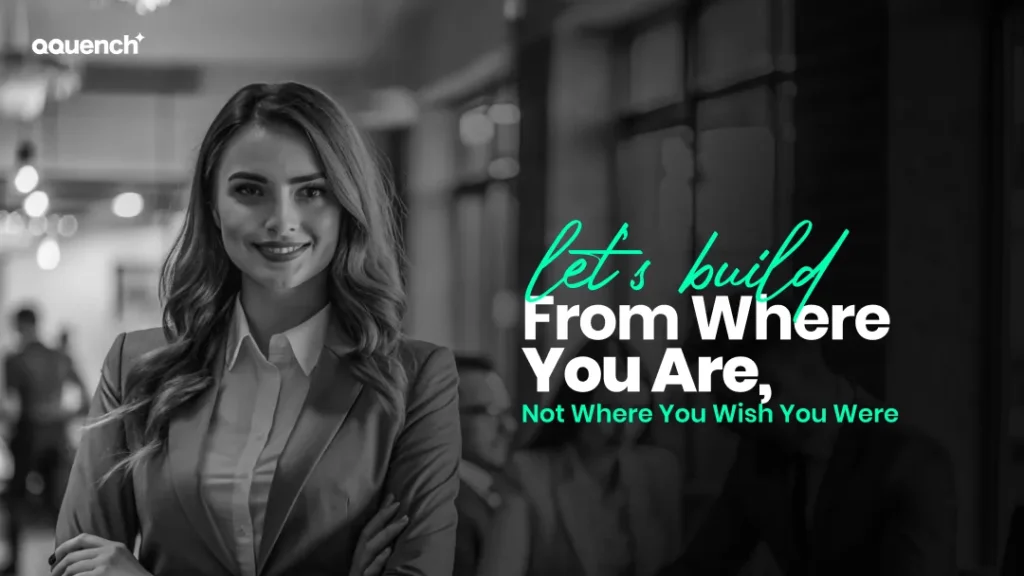 Confident businesswoman in a modern office setting with quote “Let’s build from where you are, not where you wish you were” – promoting strategic eLearning development tailored to current organizational readiness.